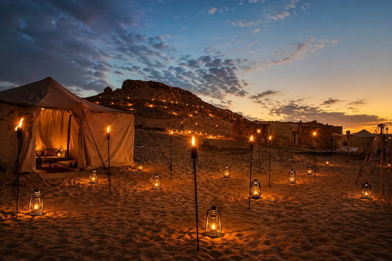 Siwa Oasis Luxury Tour desert camp at sunset with traditional tents and lanterns
